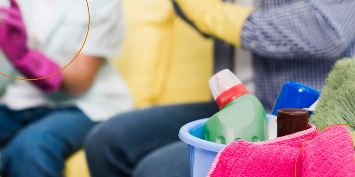 Cleaners sit next to a bucket full of cleaning supplies