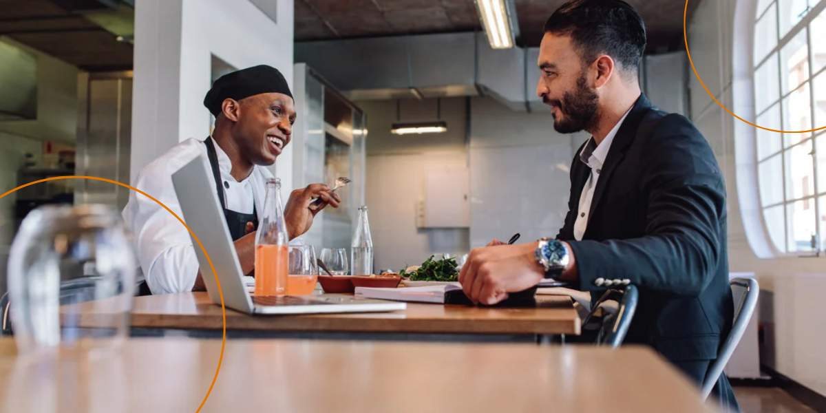 A restaurant owner talks to the head chef during a meeting