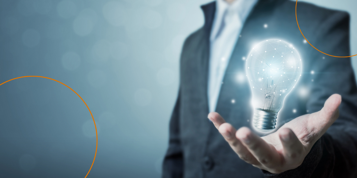 A businessman holds a digitized lightbulb in his hand