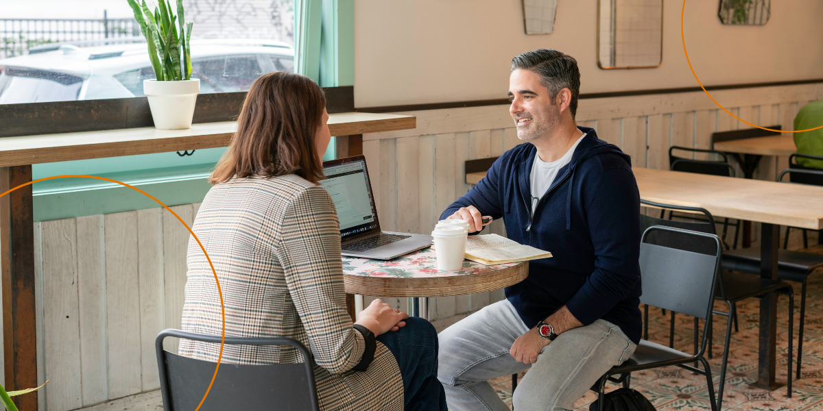 A male franchisee and a female franchisor meet to discuss the franchise